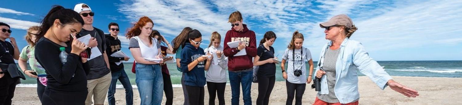 Teacher and students in class at beach